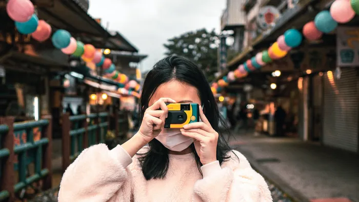 girl with a single use camera